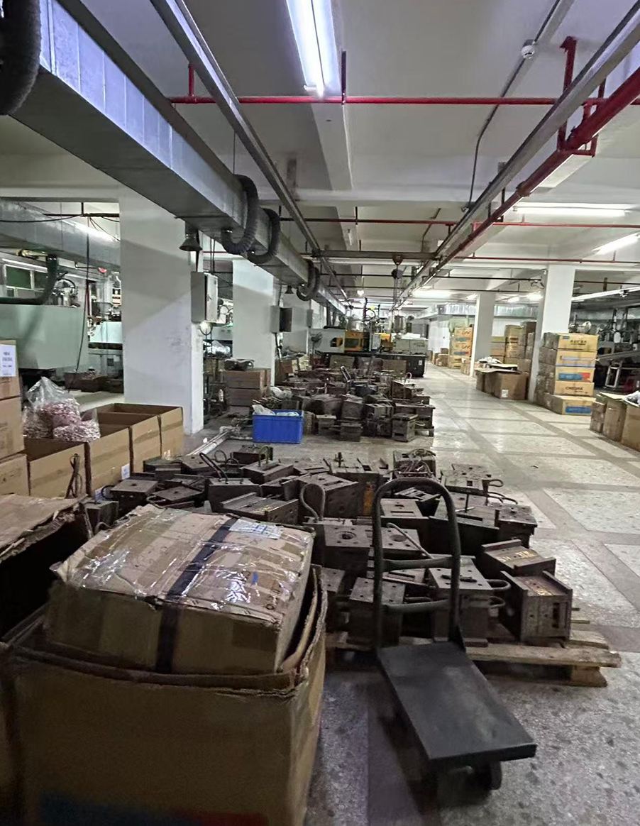 Steel injection molds stacked on a factory floor
